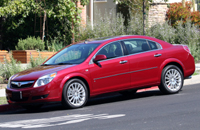 A three-quarter front view of a red 2007 Saturn Aura XR